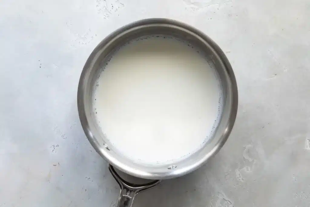 Calentar la leche a una temperatura de 180 grados (°F) para la crema pastelera.